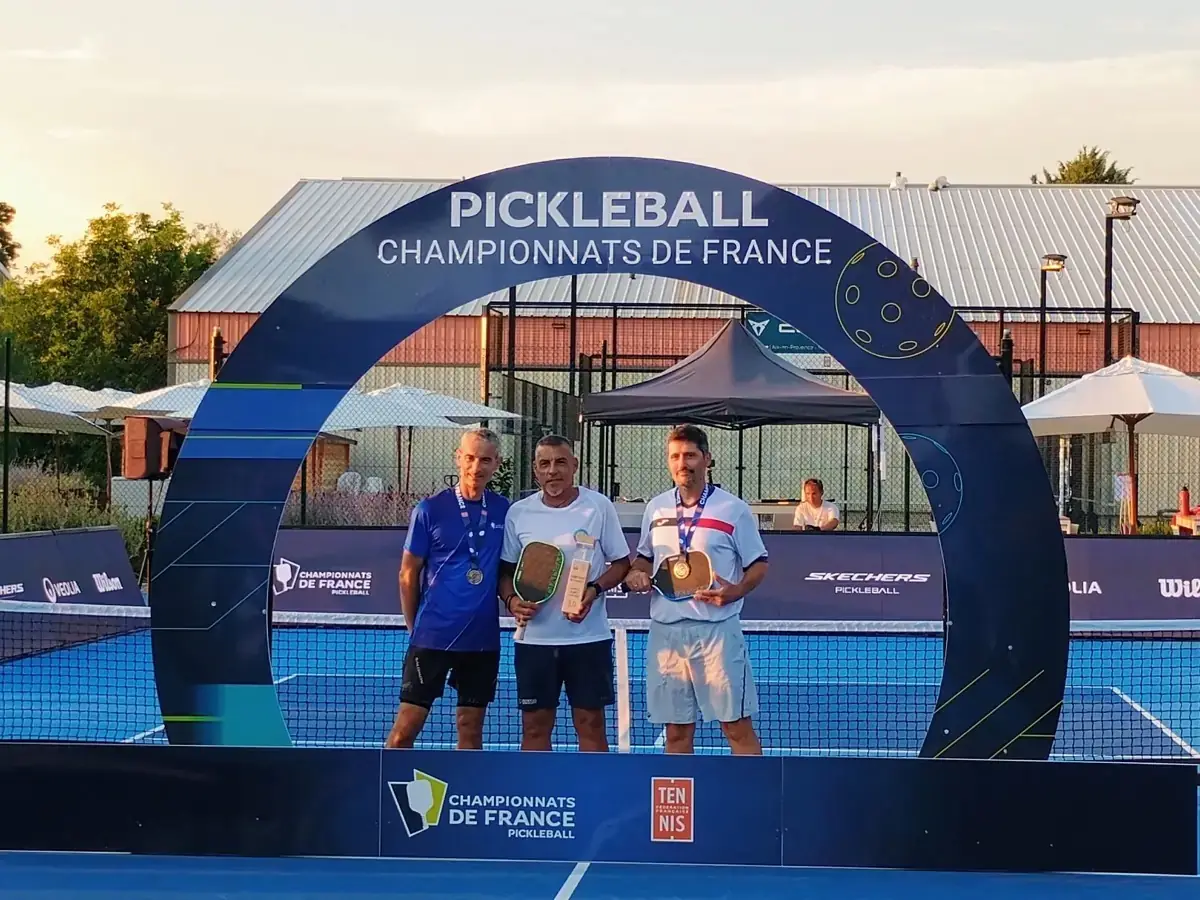 Vainqueur d’un tableau de simple levant son trophée au centre du podium